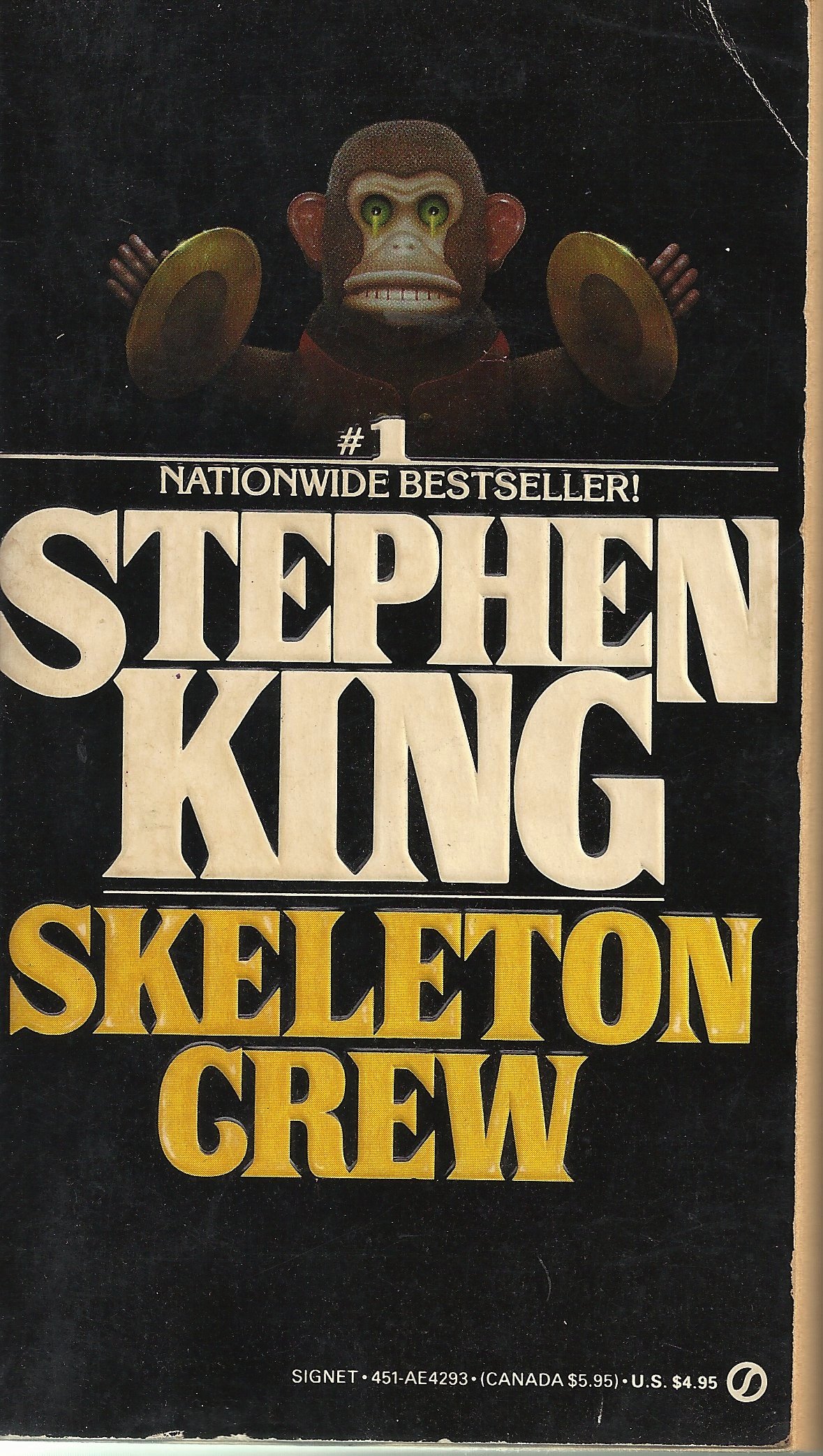 Halloween: Cover of Stephen King's "Skeleton Crew." Above the title is a monkey toy with green eyes that is holding symbols. Also above the title is a line stating "#1 Nationwide Bestseller!"  