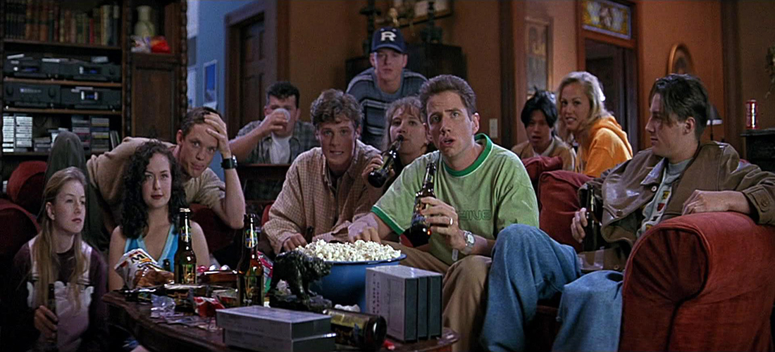 Randy watches a horror movie with his classmates prior to explaining what not to do in a horror movie in order to survive in 'Scream.'