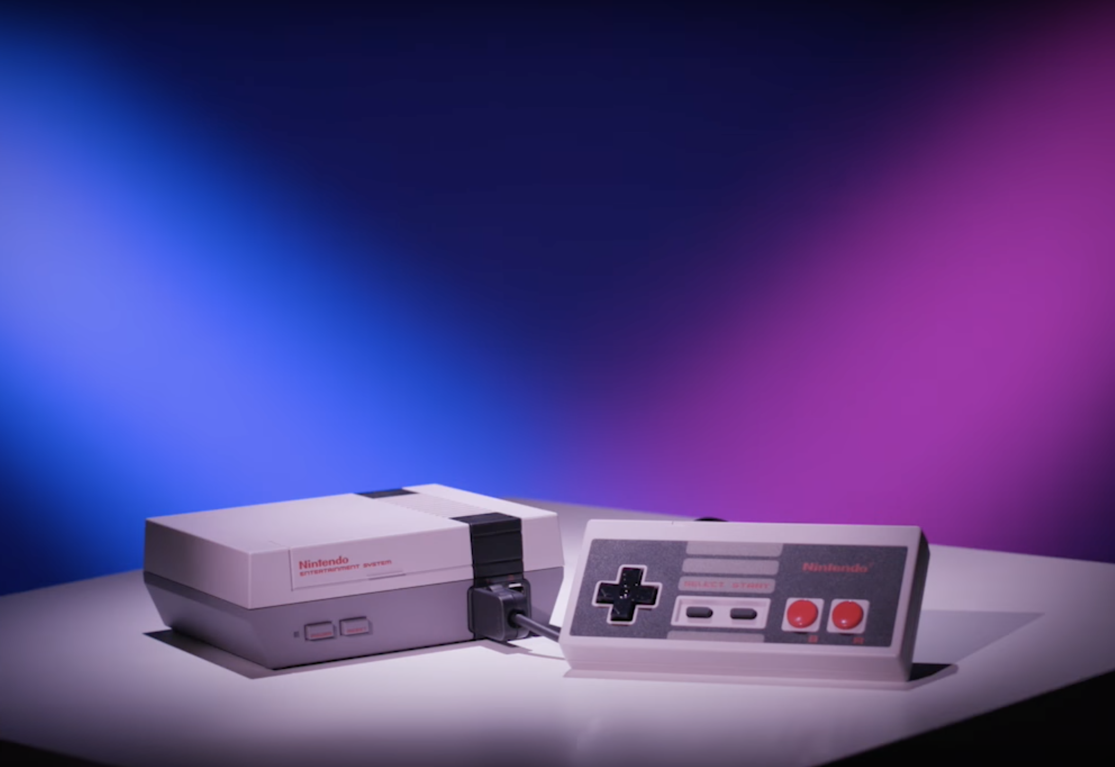 An image of the NES system against a blue and pink strobe-like background.