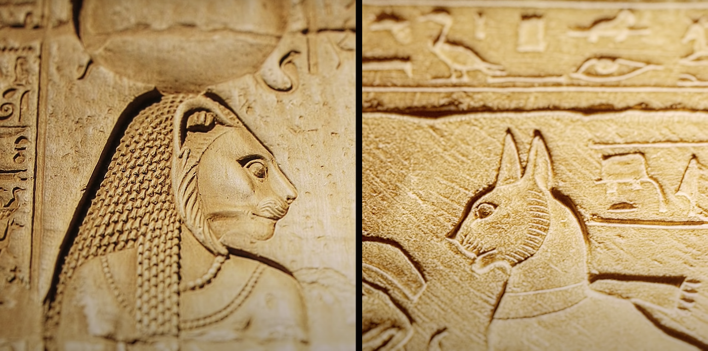 Ancient Egyptian wall carving of the goddess Bastet, pictured alongside a carving of a cat. 