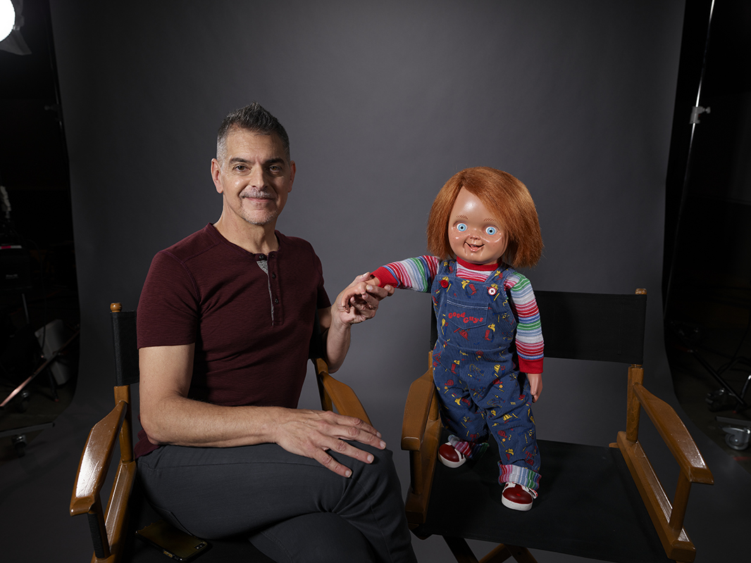 Don Mancini and Chucky. (Photo By: Brendan Meadows/SYFY.)