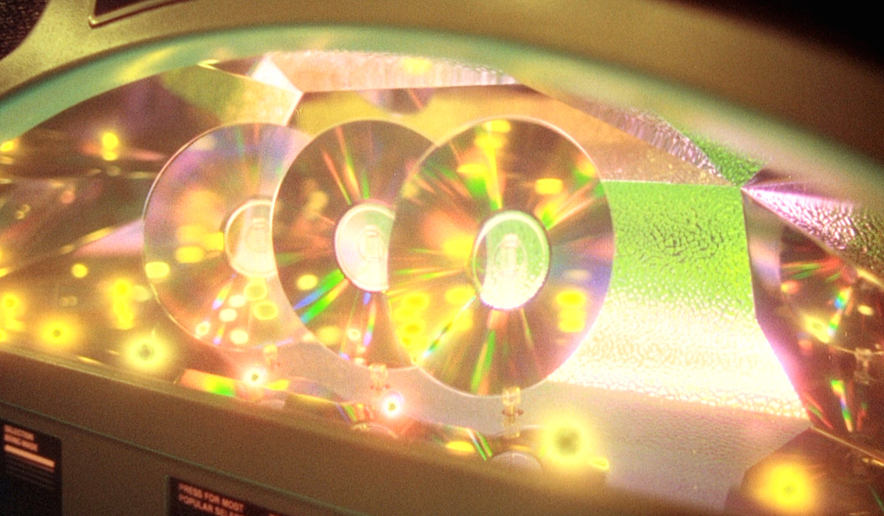 This is a photo of the neon jukebox, a close-up of three CDs swirling together, never touching. 