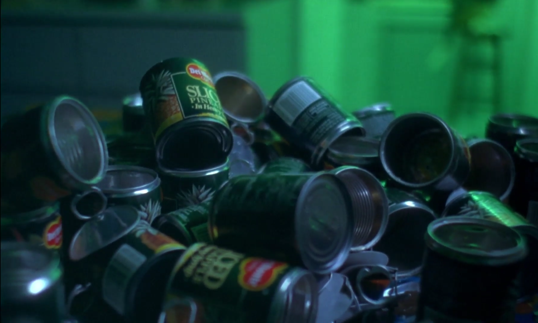 A still from Chungking Express that shows a pile of opened pineapple cans. 