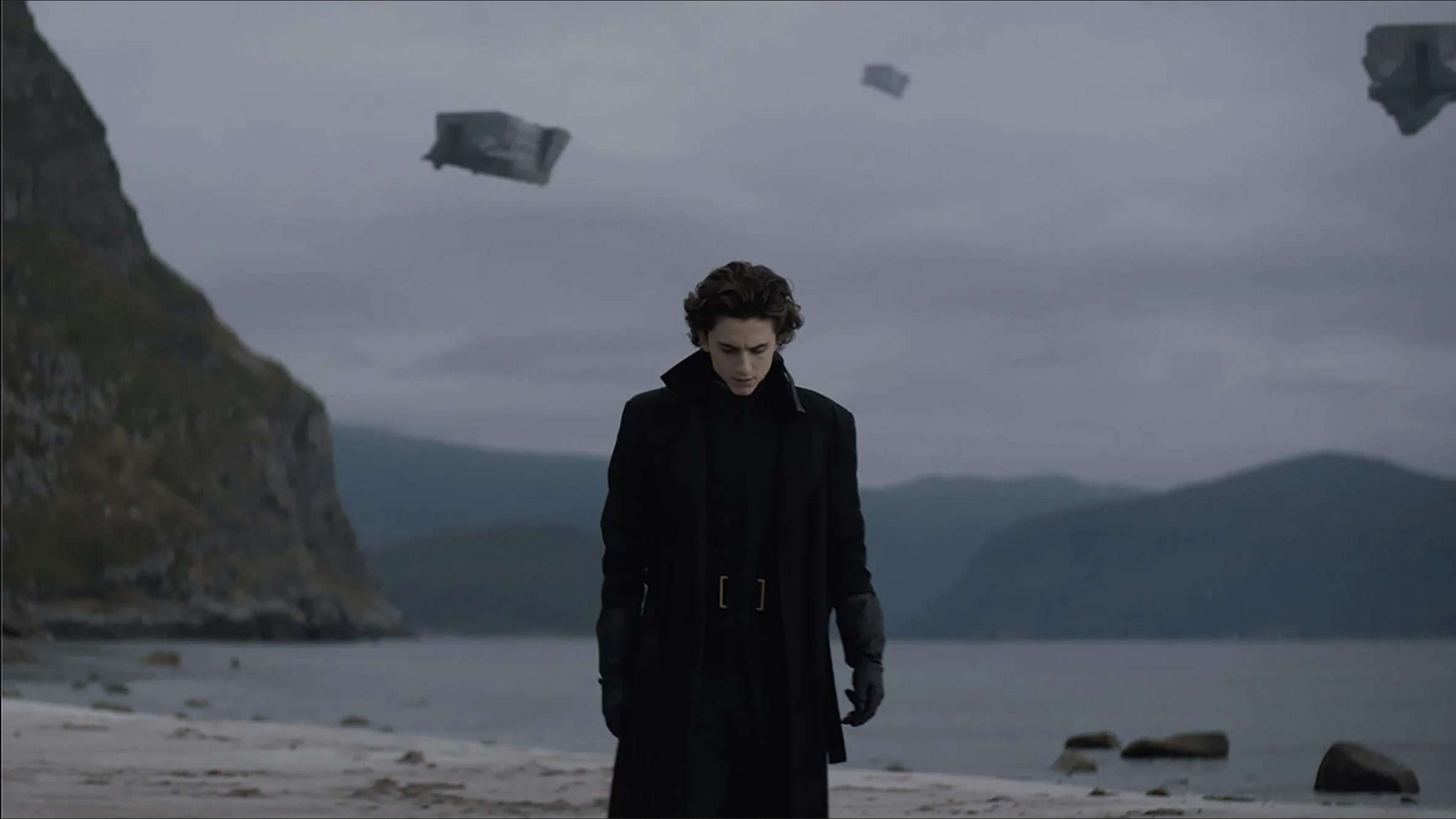 An image of Paul Atreides from the 2021 'Dune' against an overcast beach backrgound.