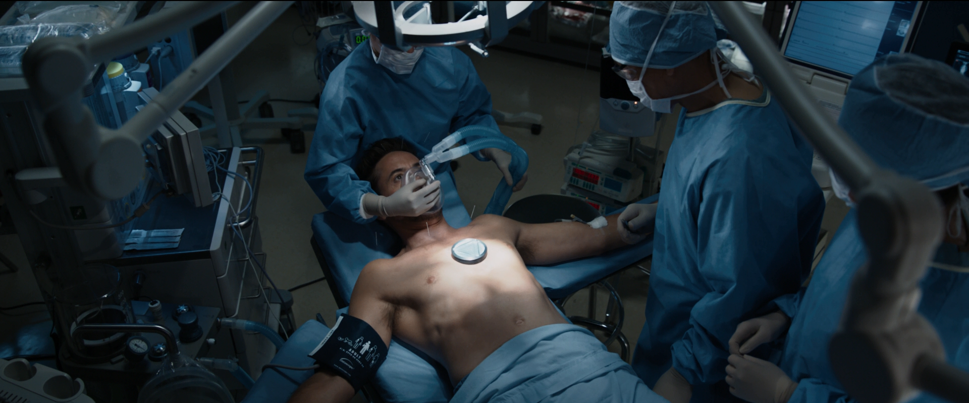 Tony Stark during the operation to remove shrapnel from his chest in Iron Man 3 (2013).