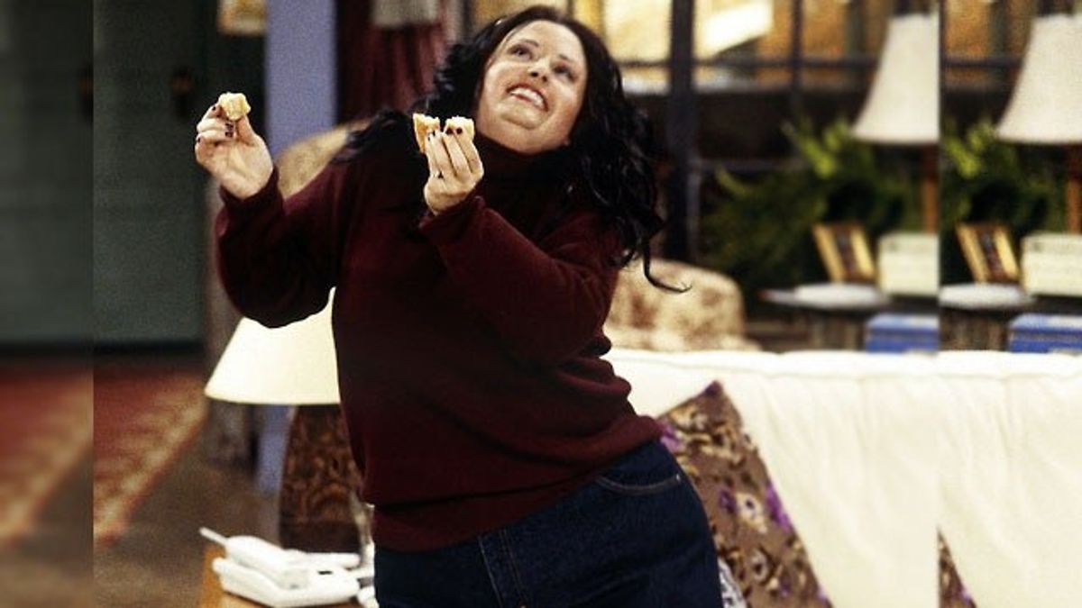 The character of "Fat" Monica dances happily with a donut in her hands. 