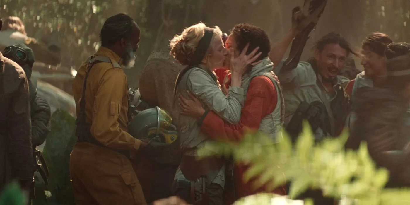 Commander Larma D'Acy (Amanda Lawrence) kisses her wife Wrobie Tyce (Vinette Robinson) a resistance pilot. Abrams, J.J. Dir. Star Wars IX: The Rise of Skywalker. 2019.