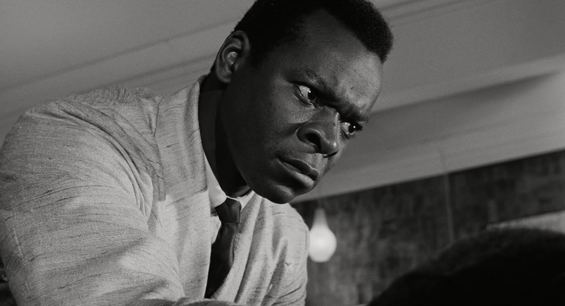 Rodriguez (Brock Peters) looks down angrily at someone off camera. Lumet, Sidney dir. The Pawnbroker. 1964