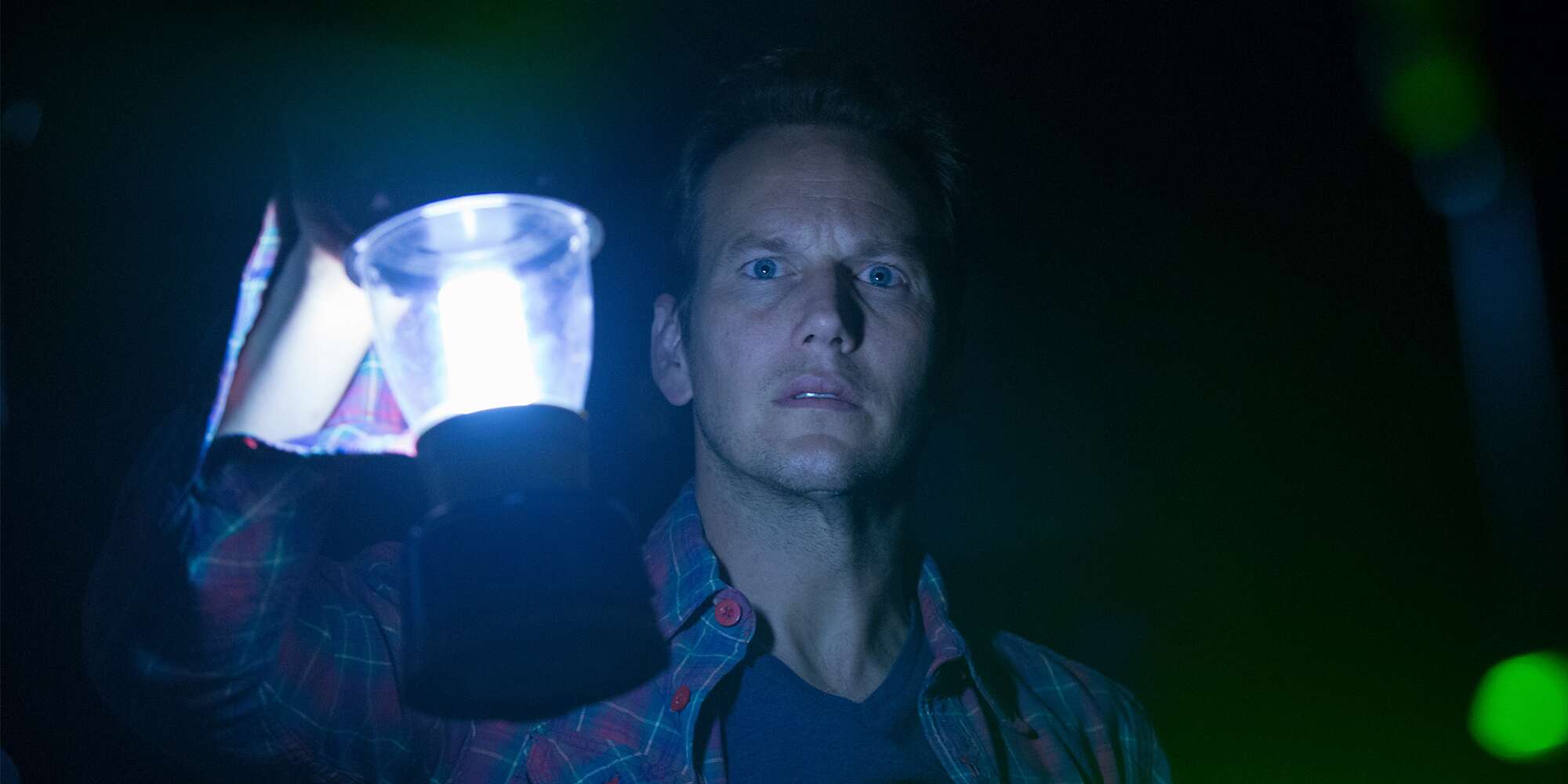 Patrick Wilson holding a lantern in scene from Insidious, 2011.