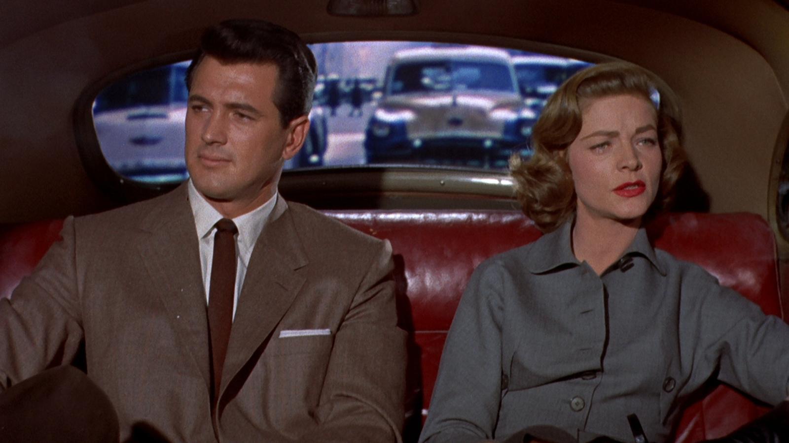 Mitch Wayne (Rock Hudson) and Lucy Moore (Lauren Bacall) still side by side in a car looking at each other. Sirk, Douglas dir. Written On The Wind. 1956