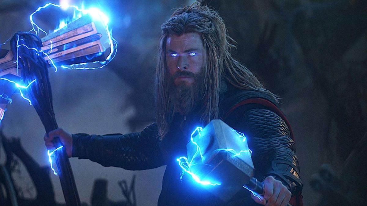 Thor stands with lightning power coursing through him, causing his eyes and hammers to glow blue. 