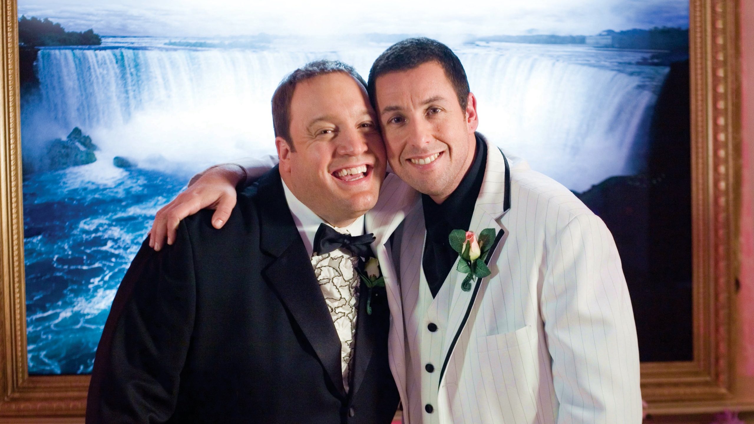 Larry (Kevin James) and Chuck (Adam Sandler) are wearing suits and stand in front of a waterfall painting. Chuck has his arm around Larry and their cheeks are pressed against each other's. Dugan, Dennis Dir. I Now Pronounce You Chuck & Larry. 2007.