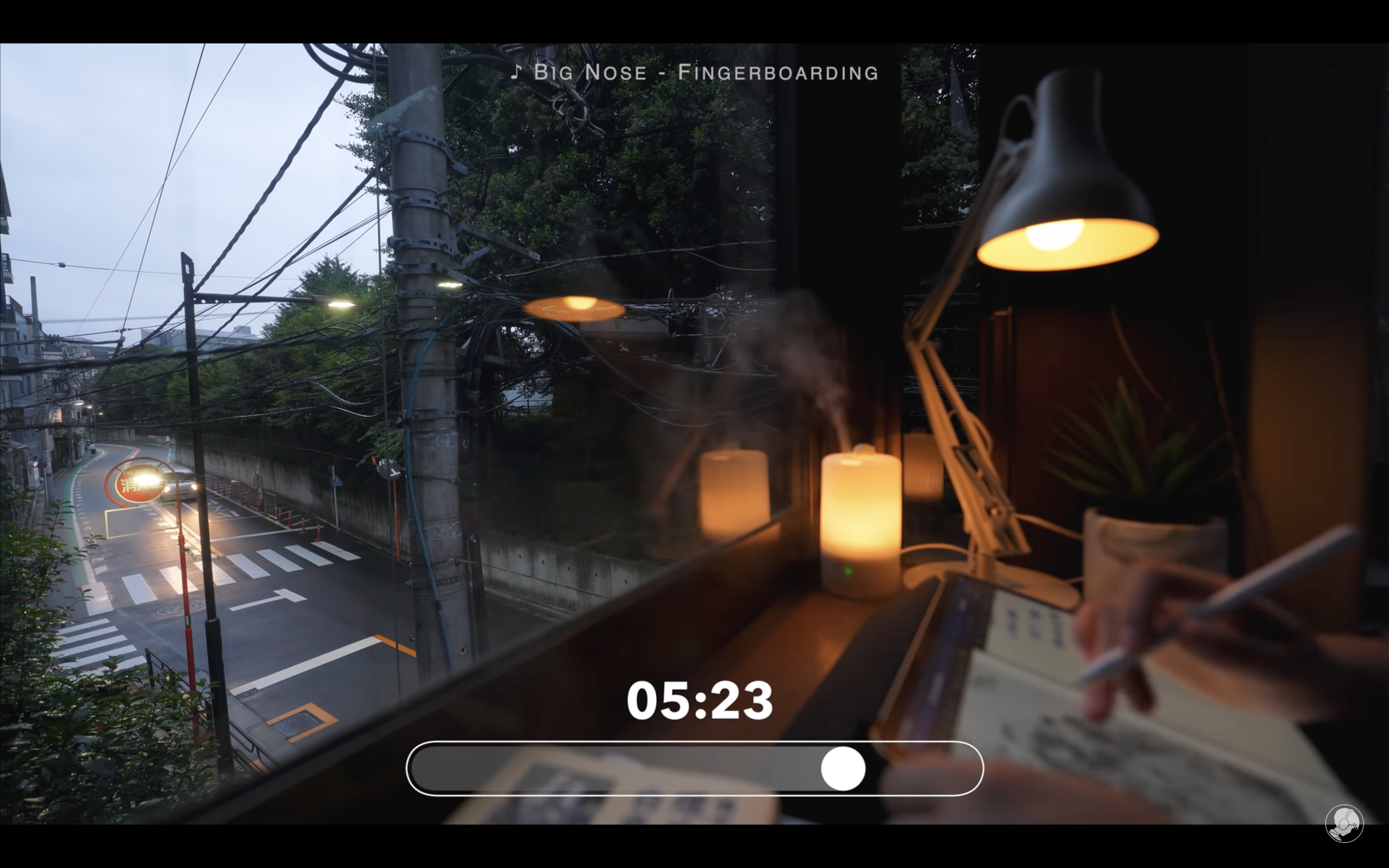 Screenshot of a "study with me" video uploaded by Abao in Tokyo. The video shows a person (face not visible) writing on a tablet while looking out the window; the song caption at the top of the screen reads "Big Nose - Fingerboarding" while a timer at the bottom of the screen reads "05:23".  