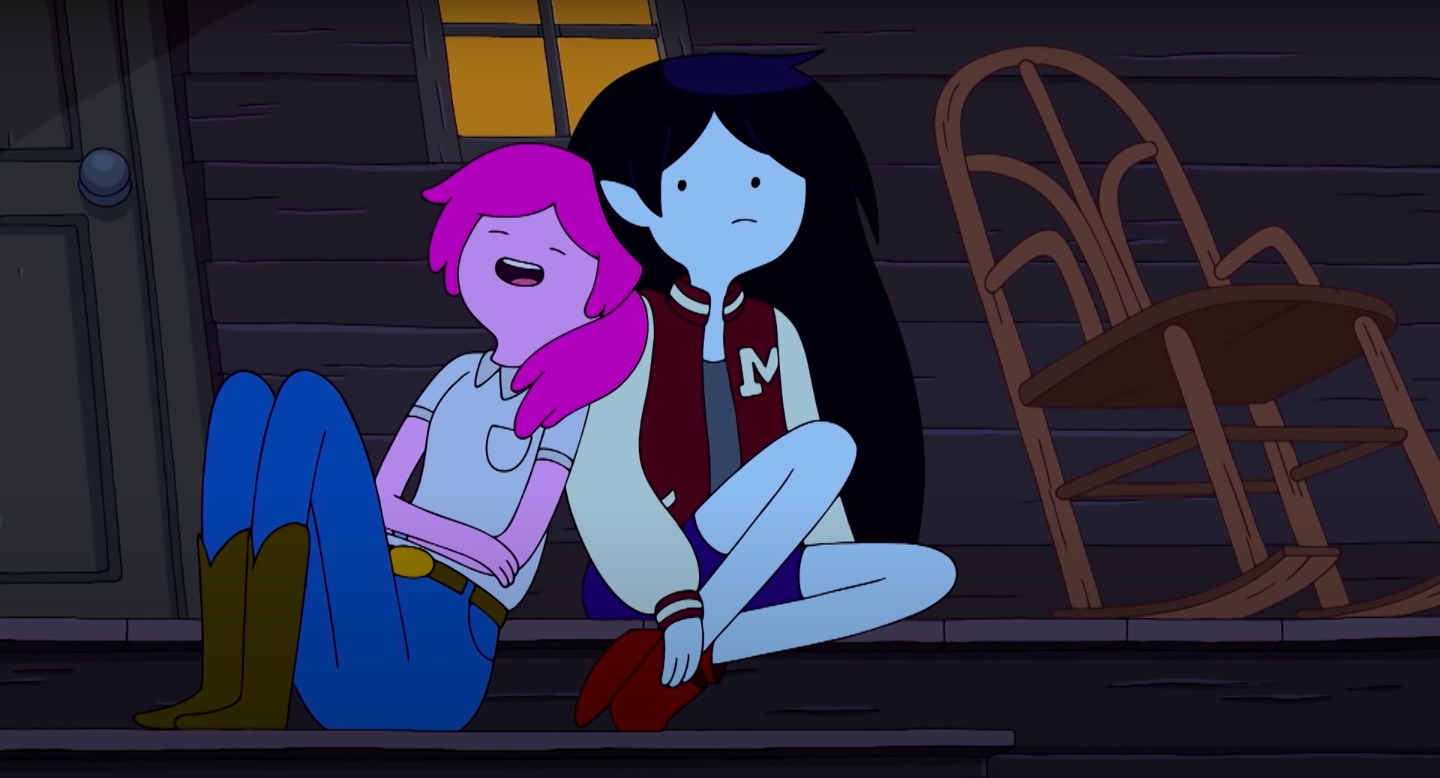 Characters from "Adventure Time," Marceline and Princess Bubblegum, share a moment together, with Bubblegum leaning her head on Marceline's shoulder. 