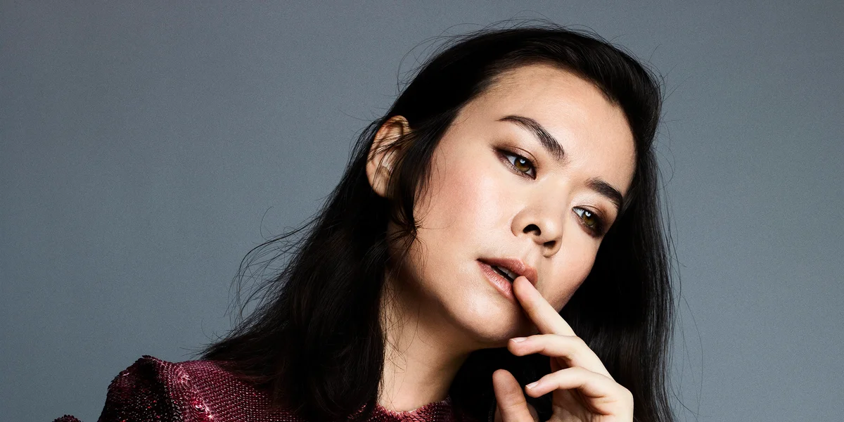Mitski's head is tilted to the right, as she gazes forlornly at something off camera. (Papermag. Oct. 2021.). 