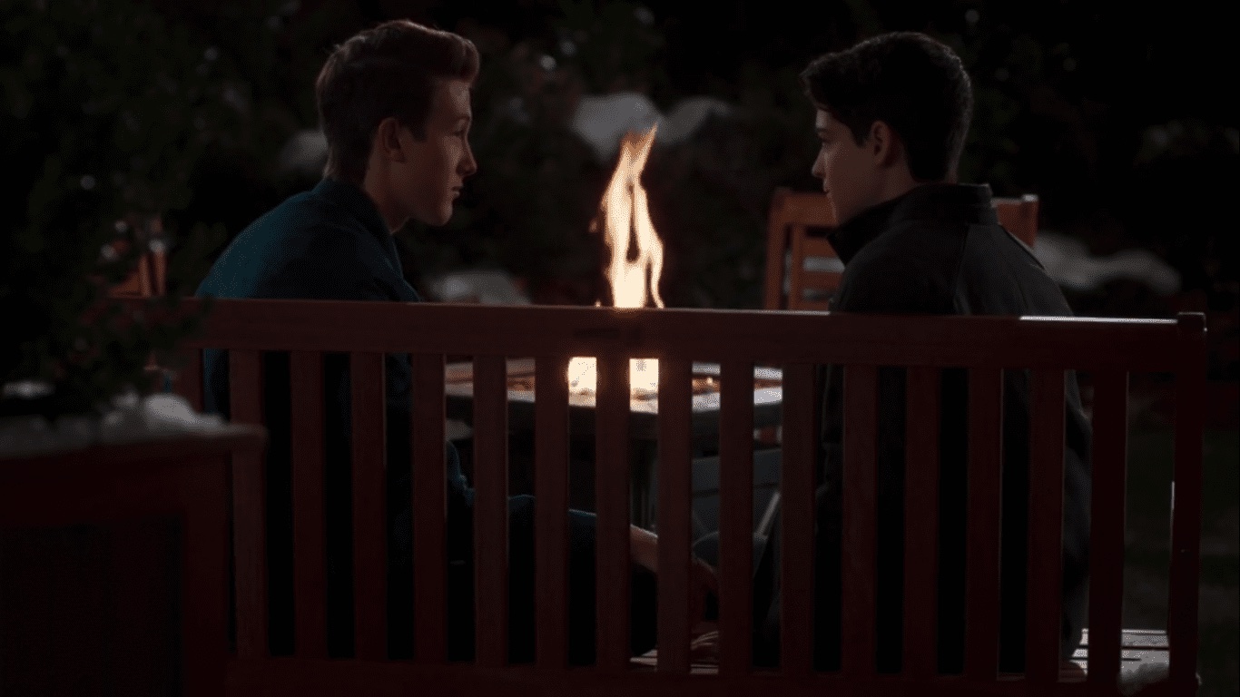 Characters TJ and Cyrus share a moment on a bench in the series finale of "Andi Mack." 