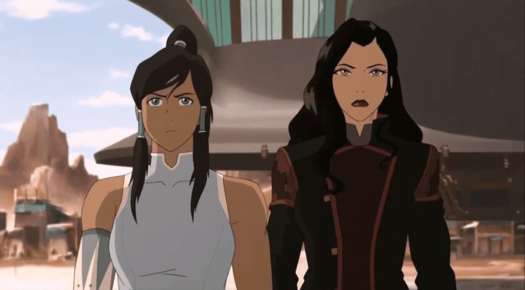 A screencap of Korra and Asami standing shoulder-to-shoulder facing the viewer from "The Legend of Korra."