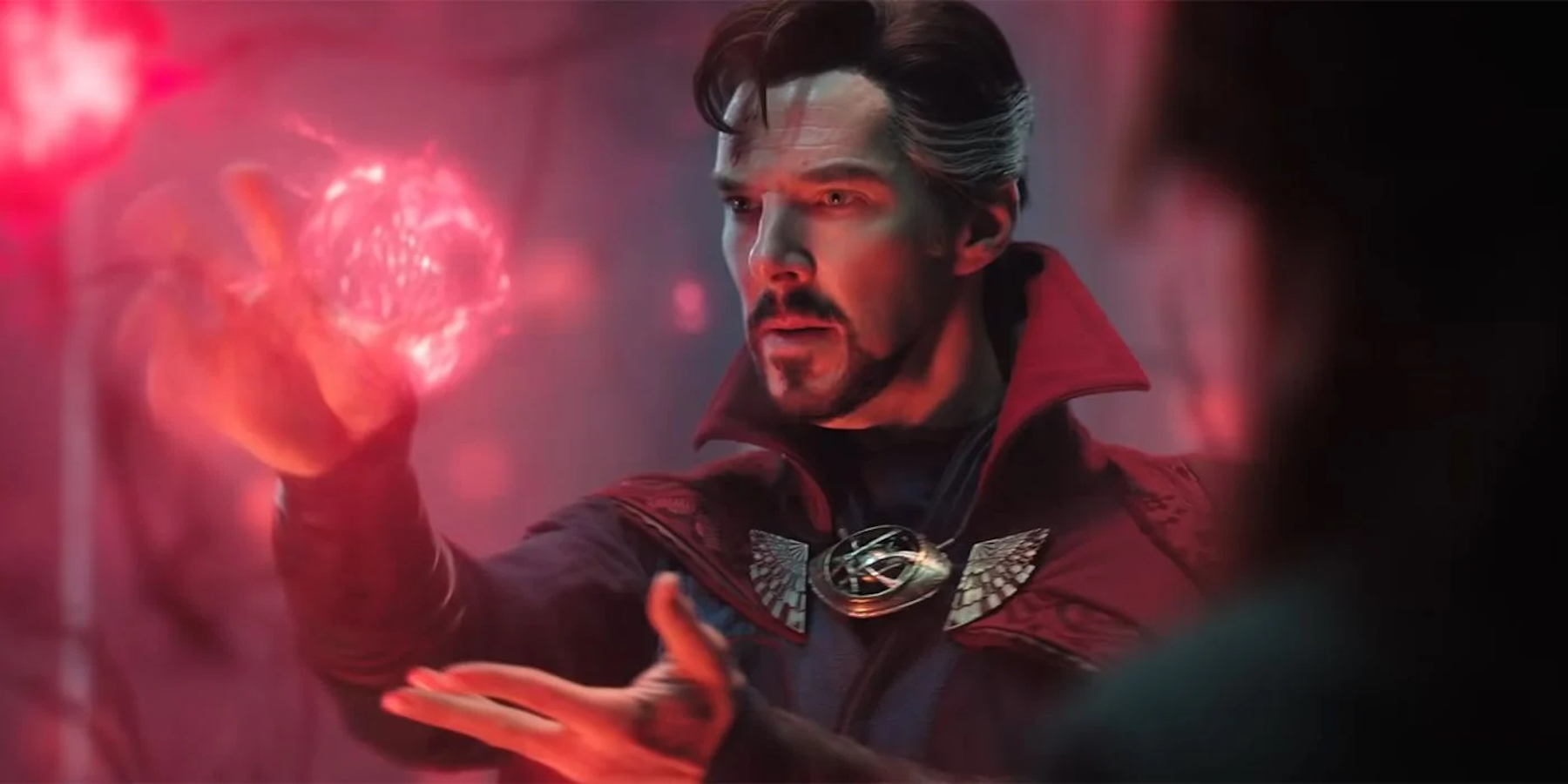Doctor Strange - played by Benedict Cumberbatch - intently manipulates a glowing red orb of energy.