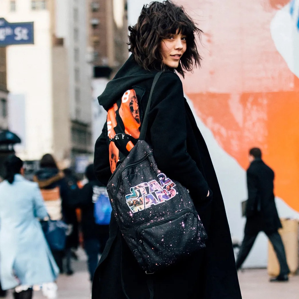 A woman wearing a "Star Wars" bag. 