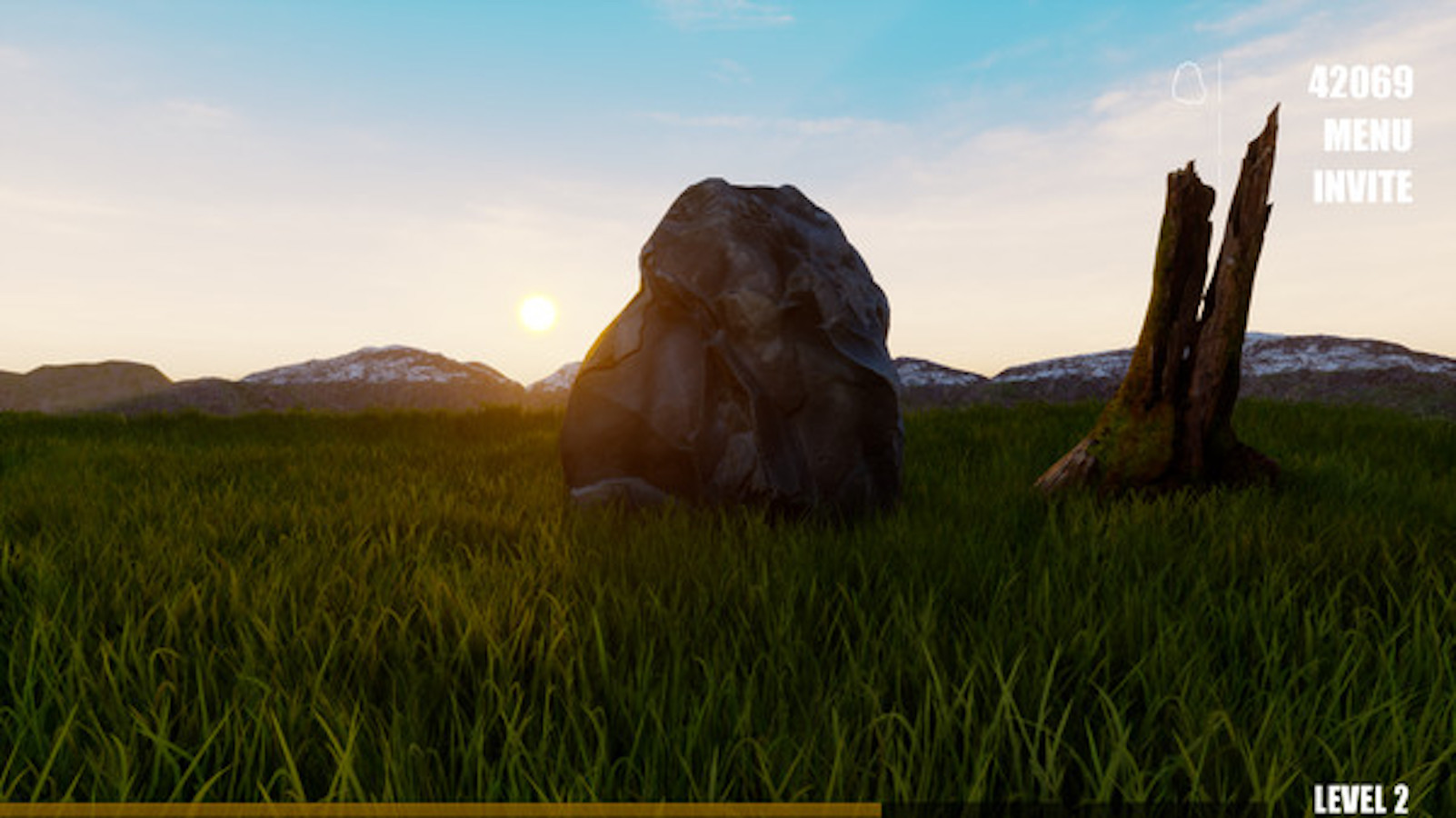 A rock sits in the center of the frame partially blocking the sprawling landscape behind it. In the distance, the sun is beginning to set over a mountain range, casting shadows on the lush green grass.