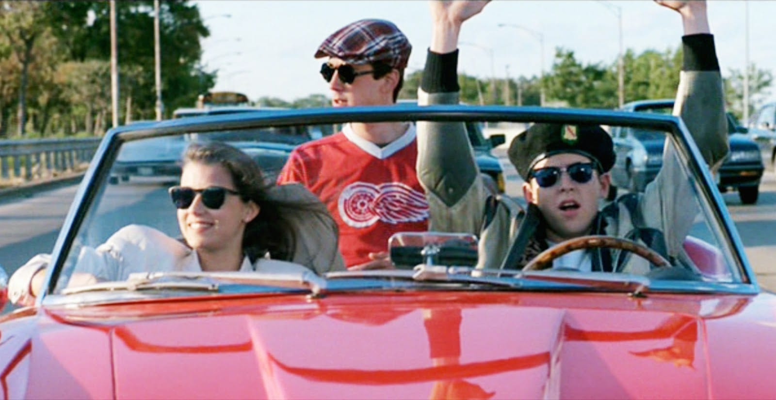 Sloane (Mia Sara), Cameron (Alan Ruck) and Ferris (Matthew Broderick) take a ride in a red convertible. 