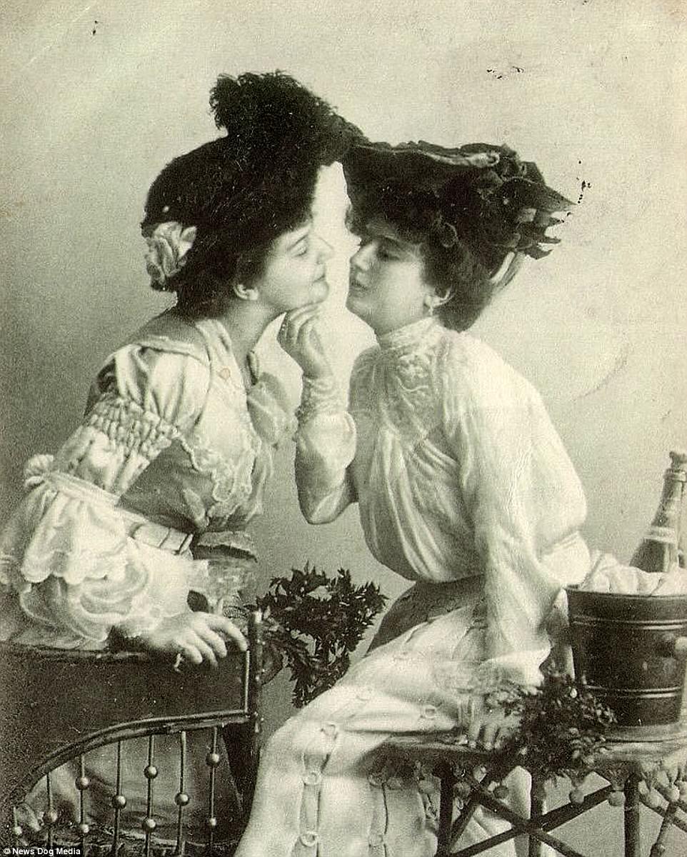 An image of two 19th century WLW women who are leaning in to each other, with one woman holding the other's chin, from the article "Portraits of illicit love: Extraordinary collection of images captures intimate displays of affection from defiant women who flouted convention in the 19th and 20th century." 