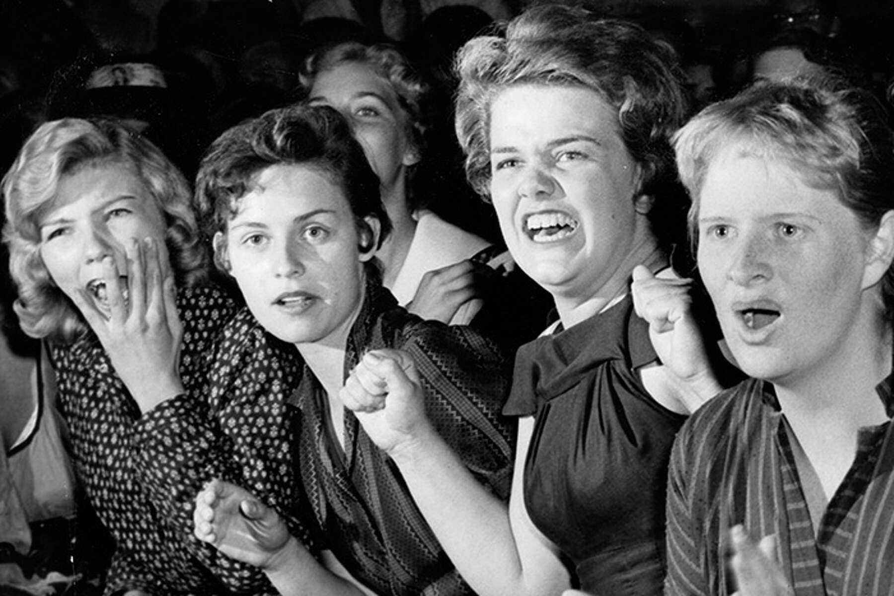 A row of cheering Elvis Presley fangirls at a performance in Houston. 