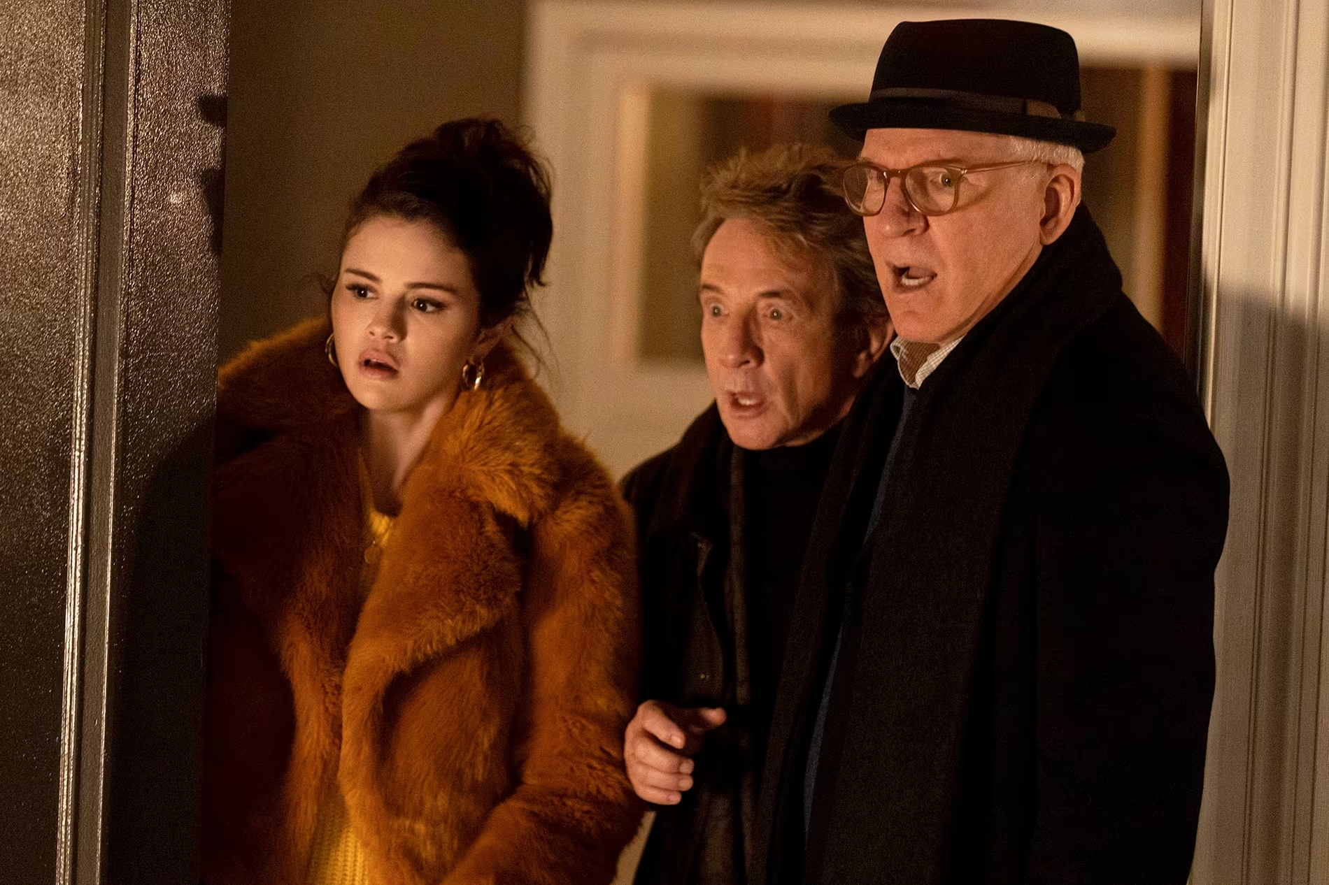 Only Murders in the Building trio, Mabel (Selena Gomez), Oliver (Martin Short), and Charles (Steve Martin) staring in shock.