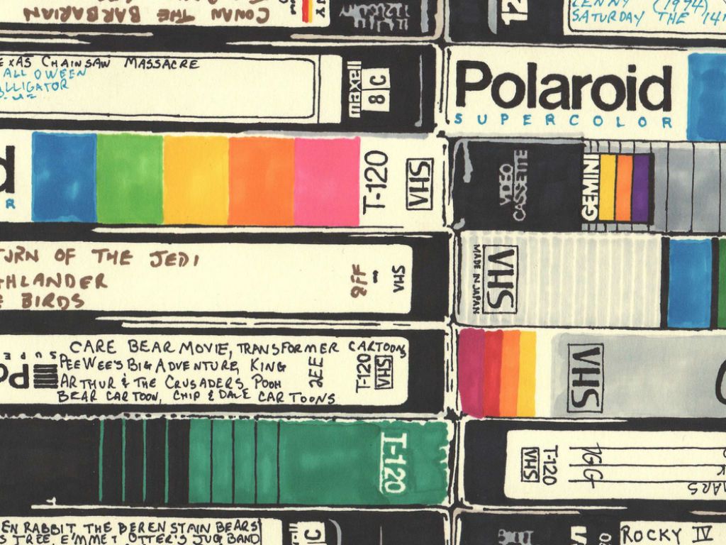 An older photo of various VHS tapes in colorful cases stacked on top of one another. 