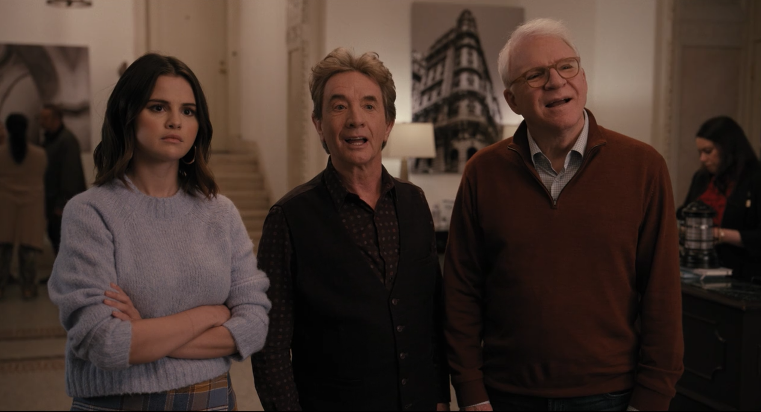 Mabel, Oliver, and Charles standing in the lobby of the Arconia.