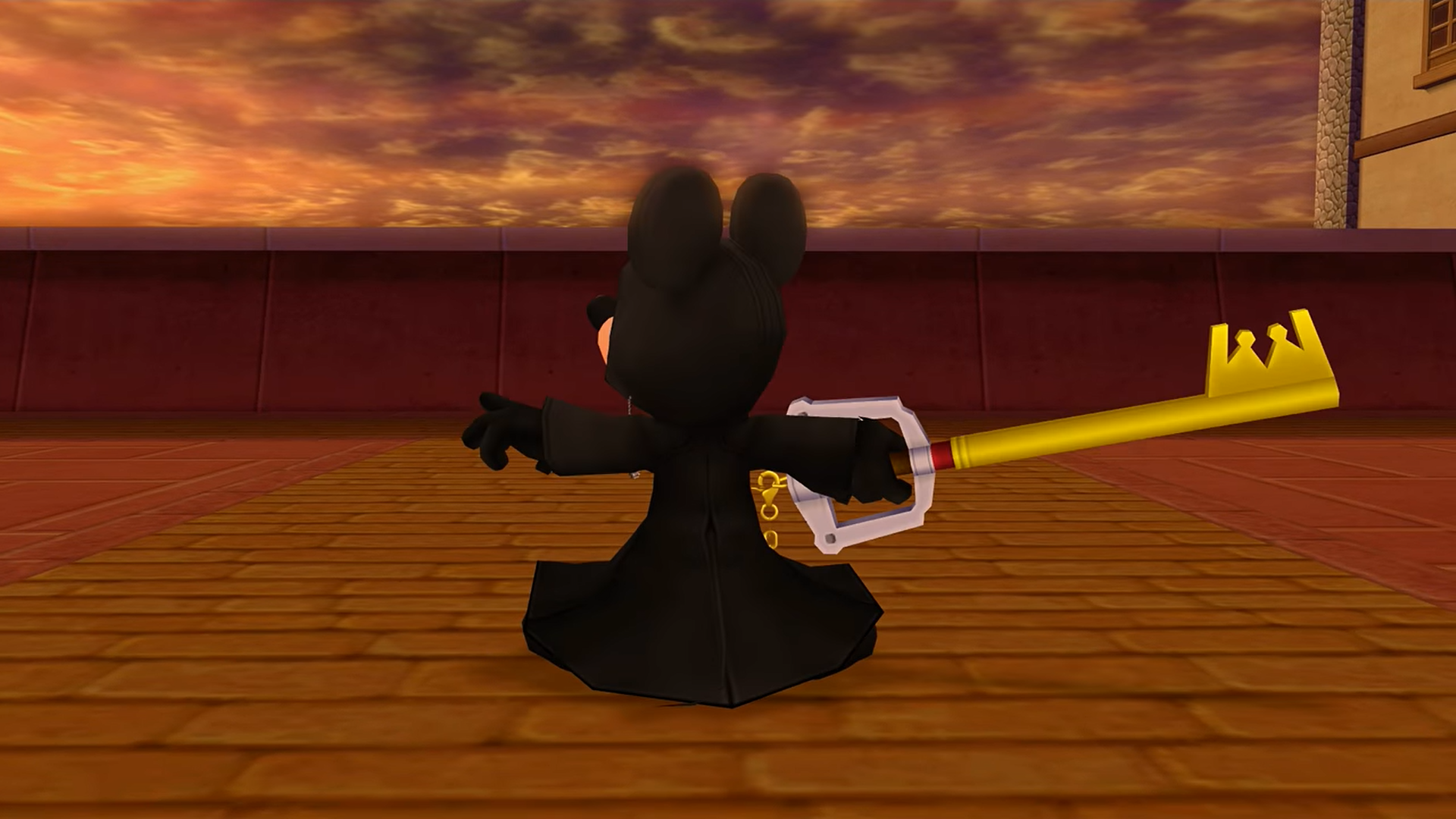 "Kingdom Hearts II". 2007. Square Enix. Disney. King Mickey is in a black coat holding a gold keyblade.