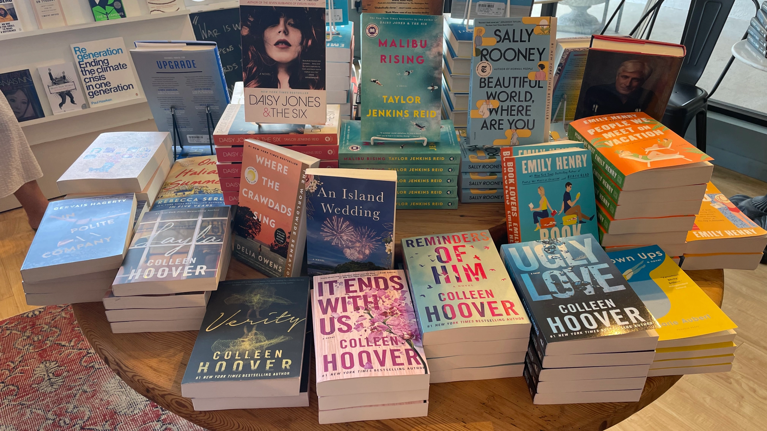 A display inside a bookstore shows several stacks of books.