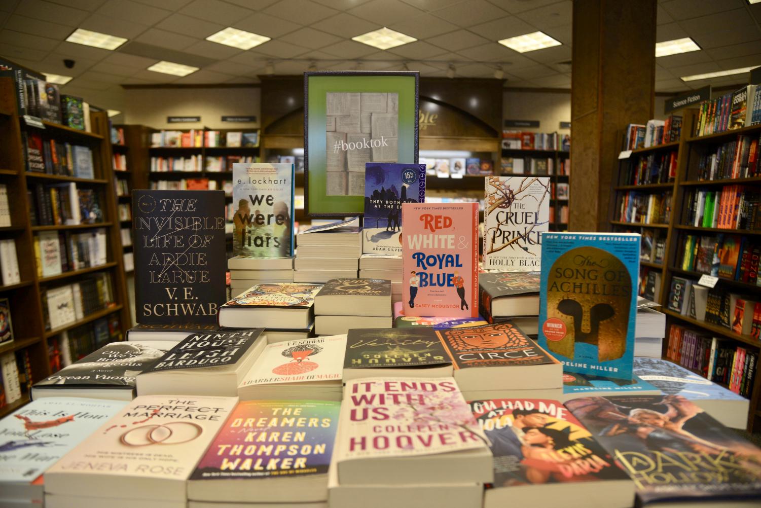 A display table inside a Barnes & Noble bookstore shows several stacks of books as well as a sign that says, "Hashtag BookTok."