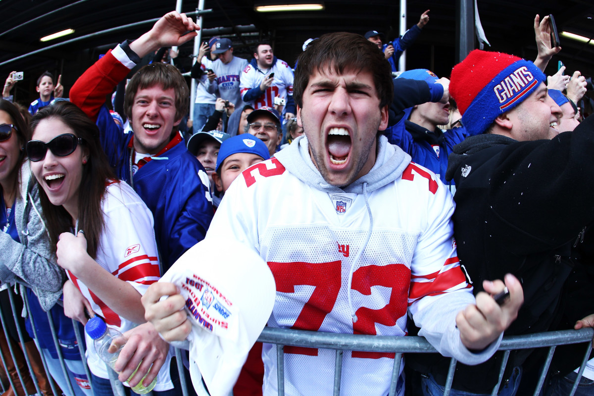 A crowd of New York Giants fans screaming at the camera happily. Al Bello. New York Giants fans. 2018.