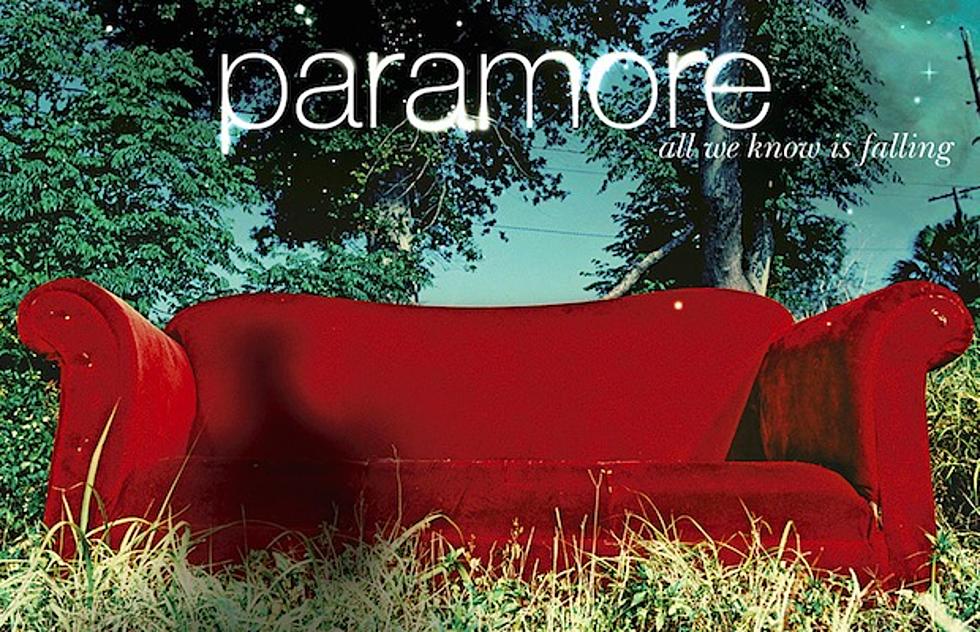 Photo features a red used couch sitting in a field surrounded by trees. "All We Know Is Falling" album art. Paramore. Fueled By Ramen. 2005. 