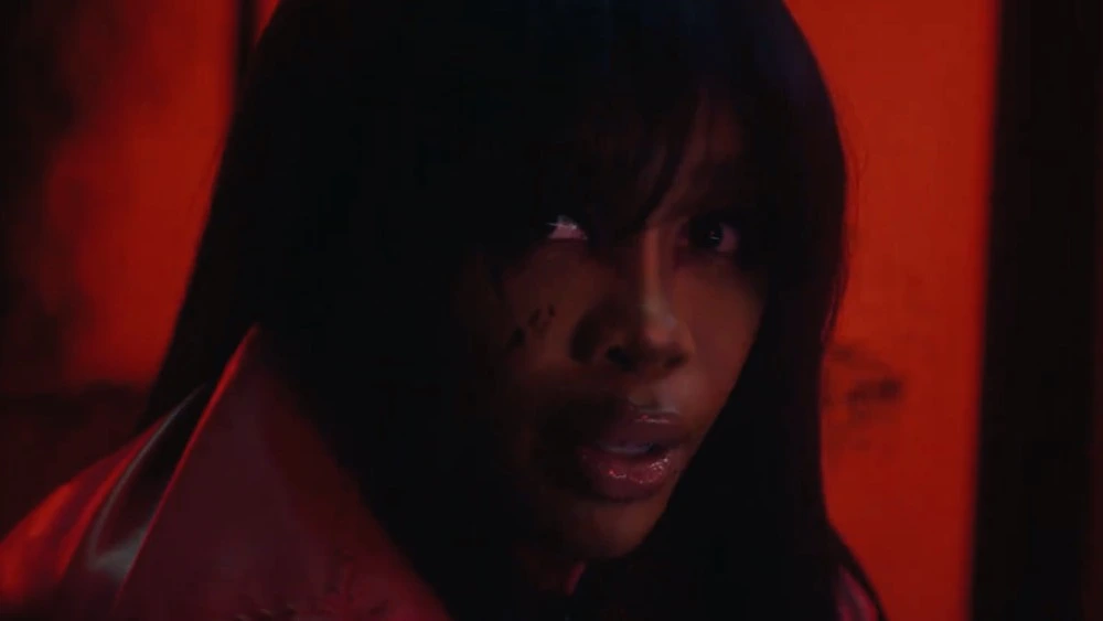 A close-up shot of SZA in her "Kill Bill" music video. She looks directly in the camera with a worried expression. 