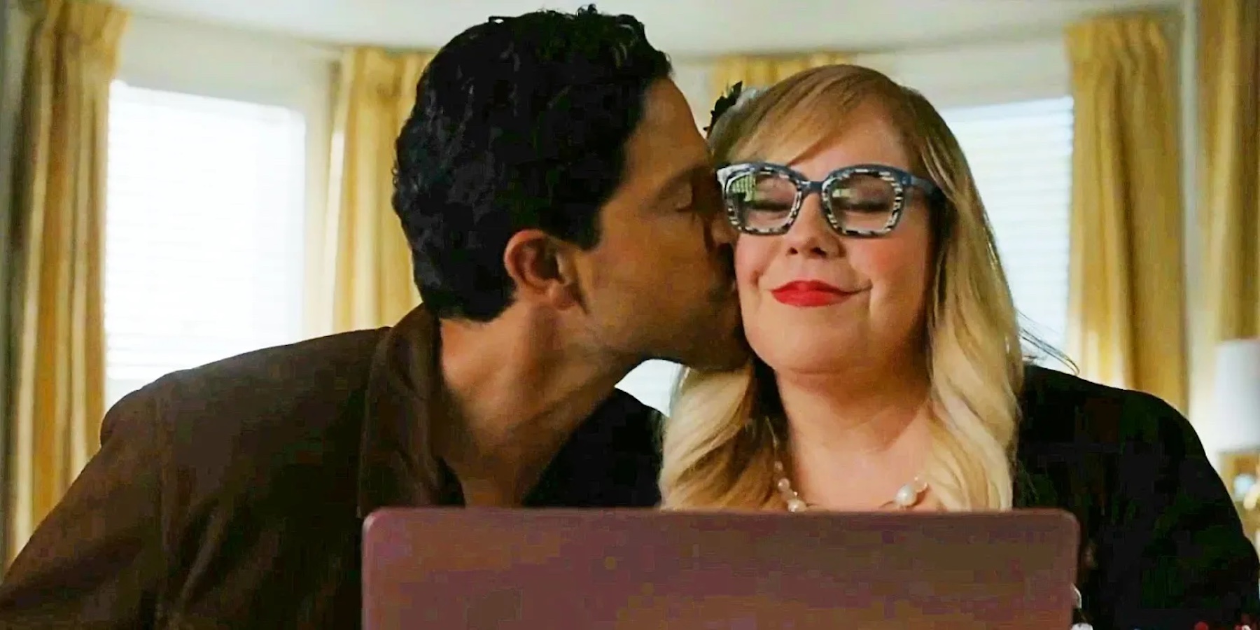 Characters Luke Alvez and Penelope Garcia sit in front of a laptop. Luke is leaning over to give Penelope a kiss on the cheek. 
"Criminal Minds." 2005-Present. CBS Studios.