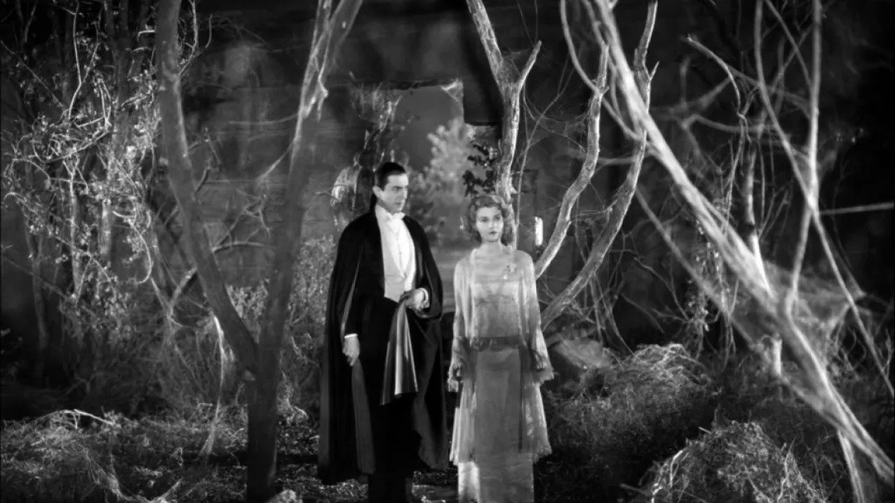 Count Dracula and Mina walking through the woods in horror film "Dracula" (1931)