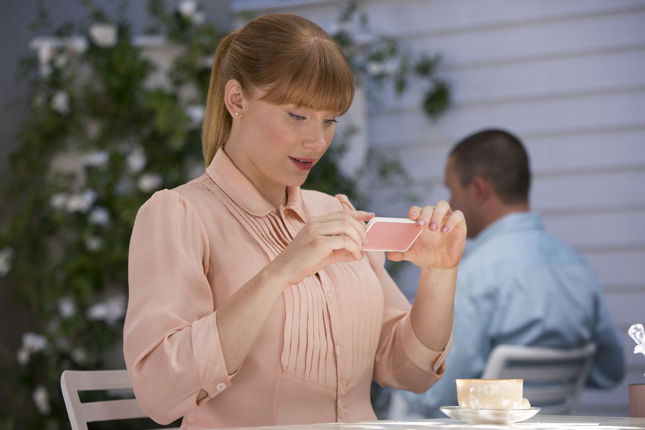 Shot from Black Mirror episode, Nosedive: Lacey looks watches something on her phone