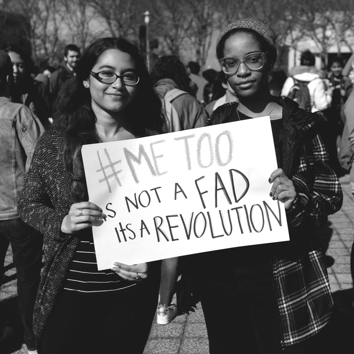 Two women holding a sign saying "#MeToo Is not a fad, It's a revolution." Global Fund For Women. 2017.