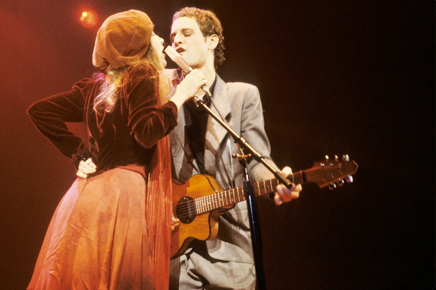 Stevie Nicks and Lindsey Buckingham perform on stage together. 
