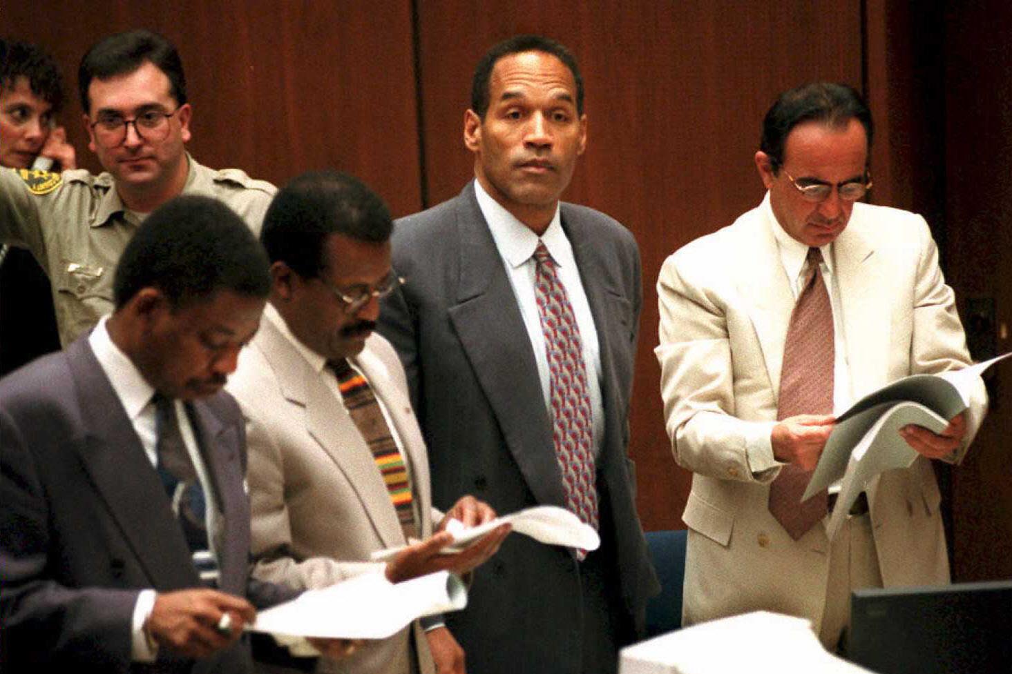 'O.J. Simpson watches as the jury in his double-murder trial enters the courtroom in the afternoon.' 02 February. (L): Carl Douglas, Johnnie Cochran Jr., Simpson, and Robert Shapiro. Murder victim Nicole Brown-Simpson's sister Denise Brown will testify. Getty Images.