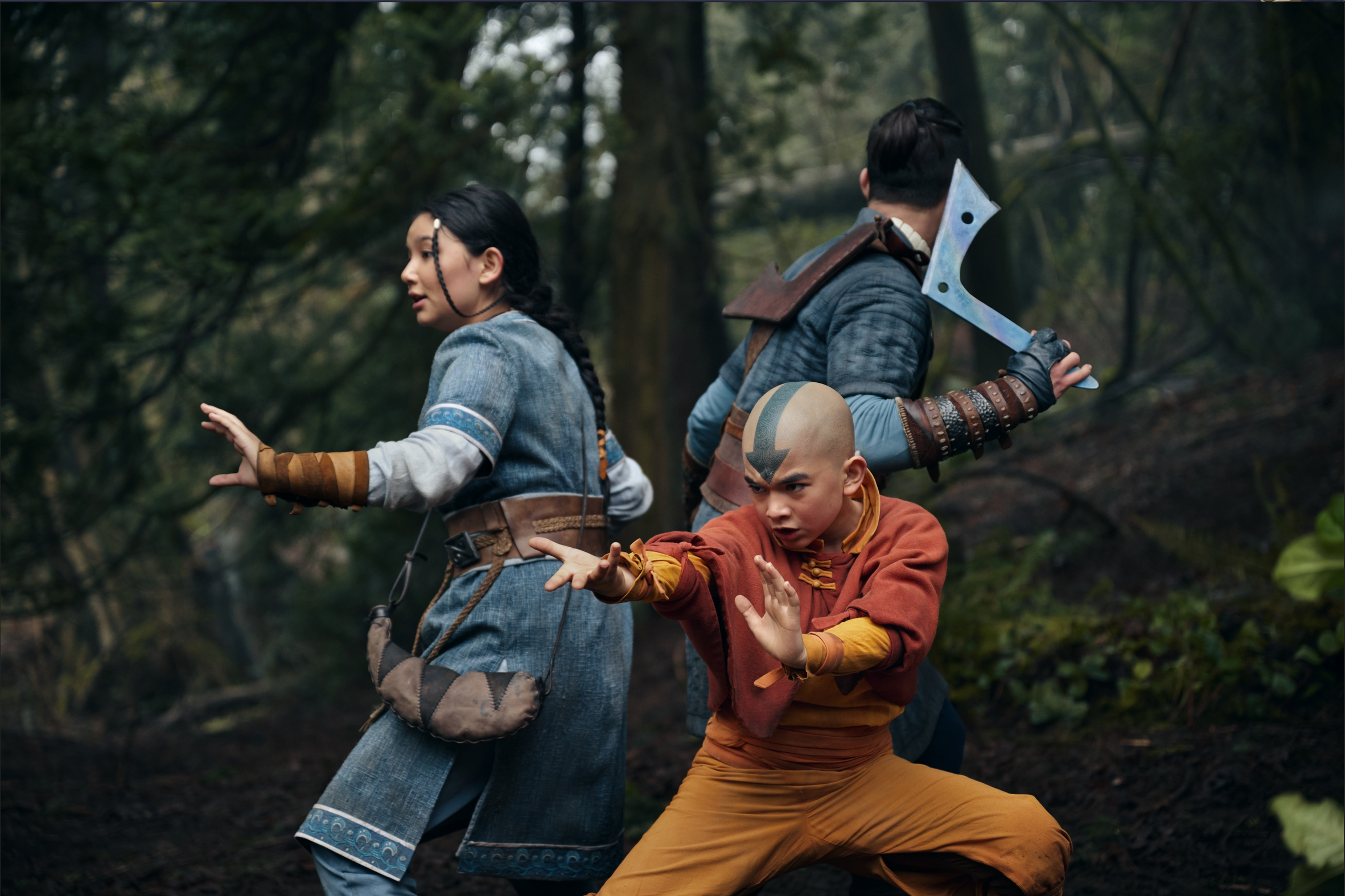 Avatar: The Last Airbender. 2024. Netflix. Aang, Katara, and Sokka preparing to fight in the woods.