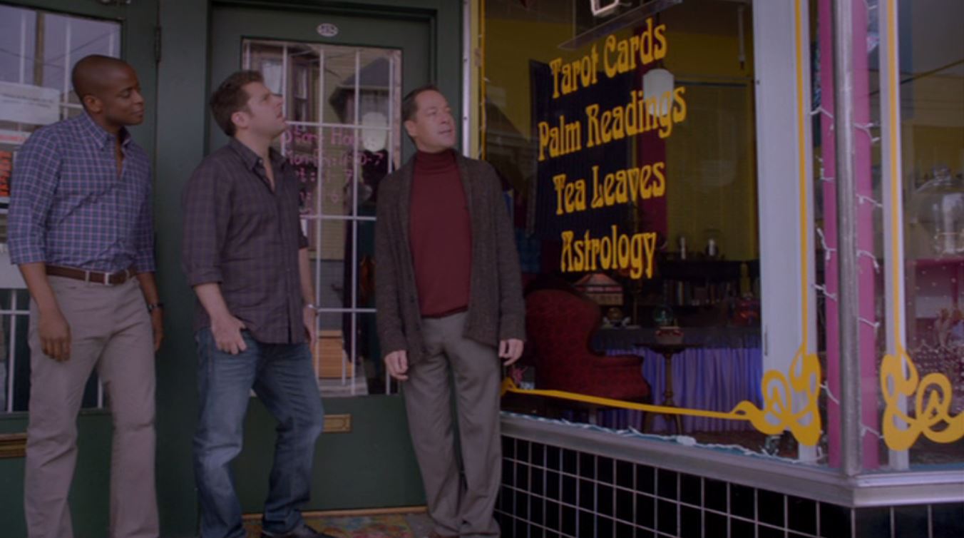 Shawn and Gus stand outside a psychic's shop. 