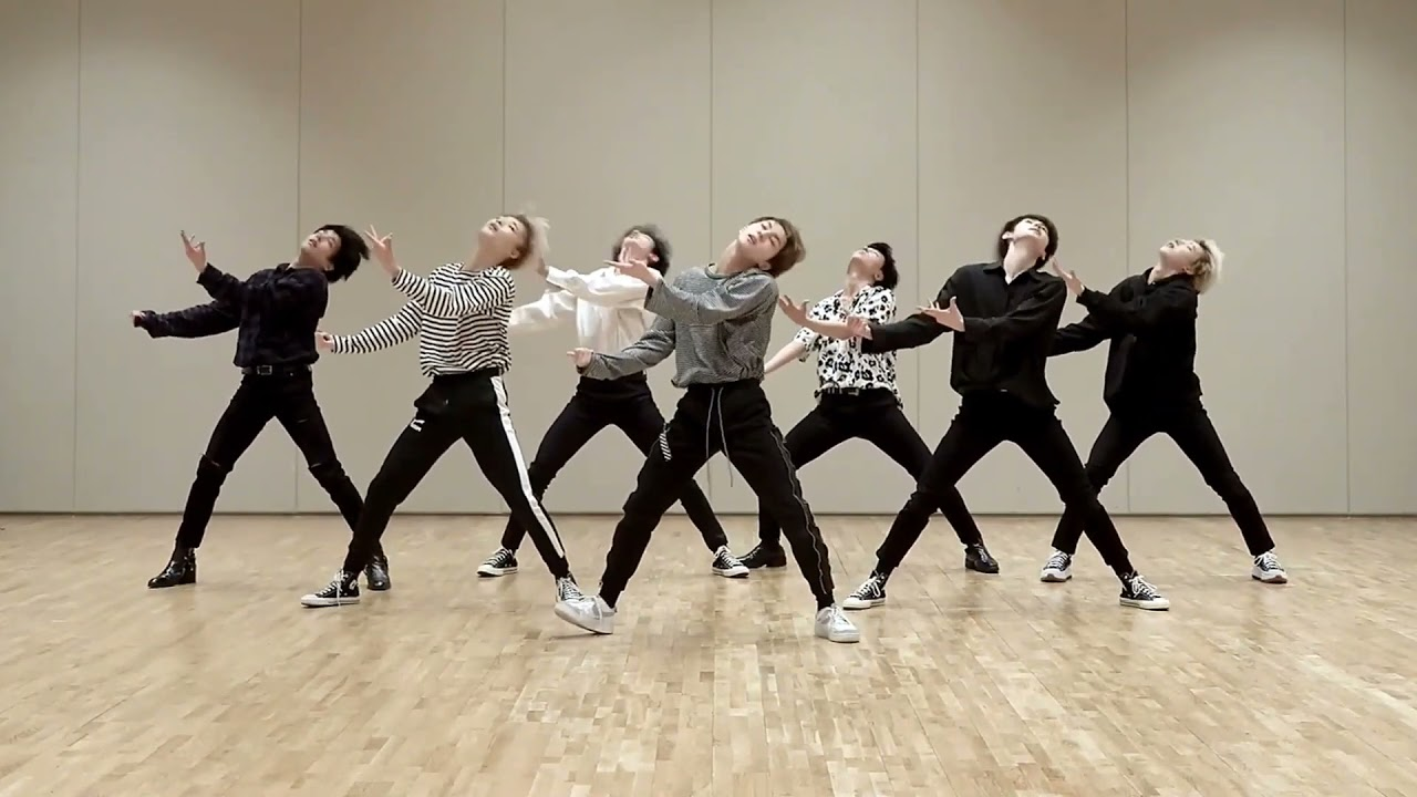 ENHYPEN members Heeseung, Ni-Ki, Jake, Jungwon, Jay, Sunghoon, and Sunoo performing "FEVER."