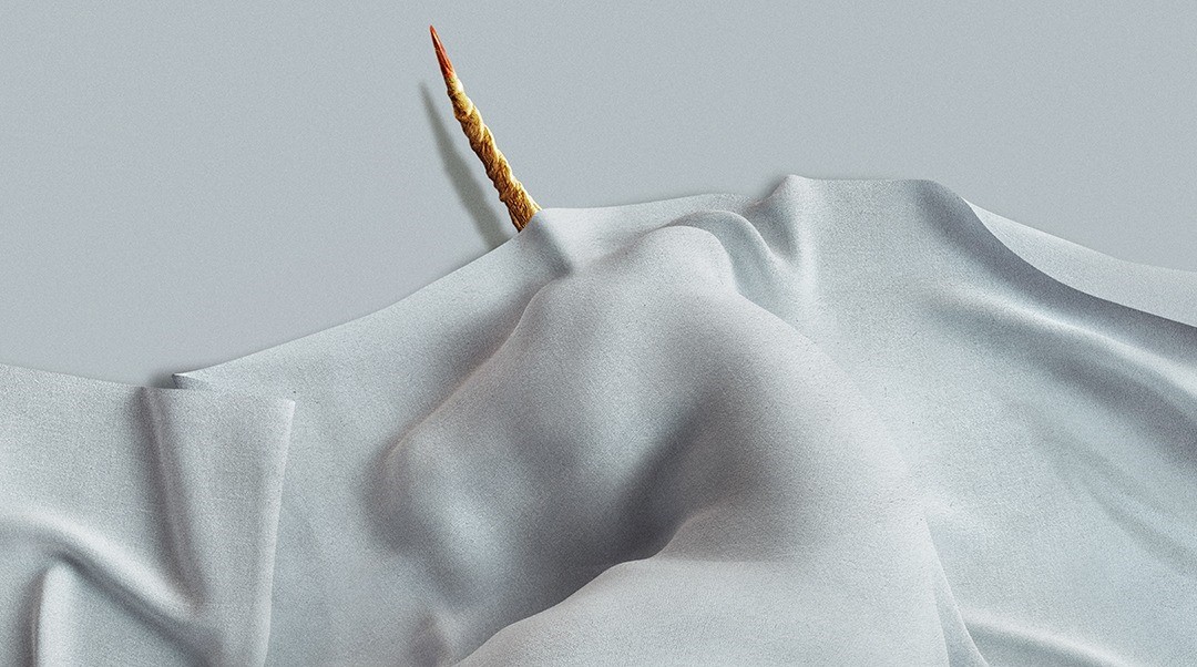 A unicorn lays under a white sheet with its horn out. Scharfman, Alex. Death of a Unicorn. 2025.