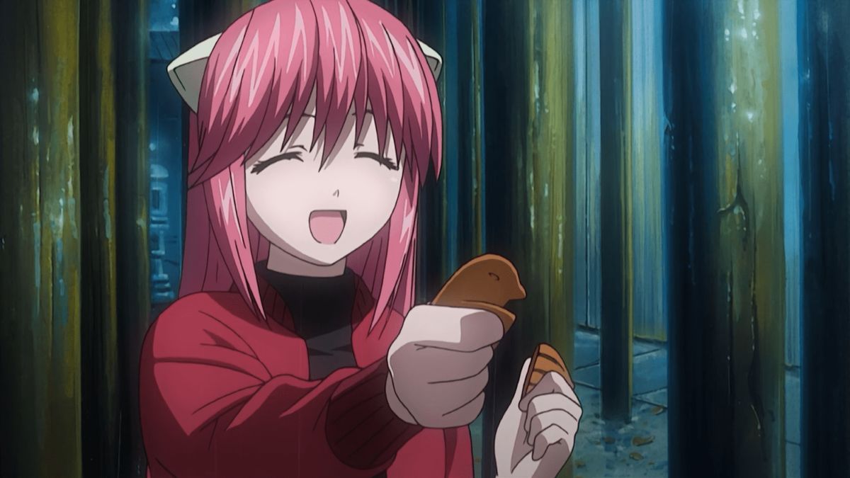 Anime girl smiling and holding a cookie.