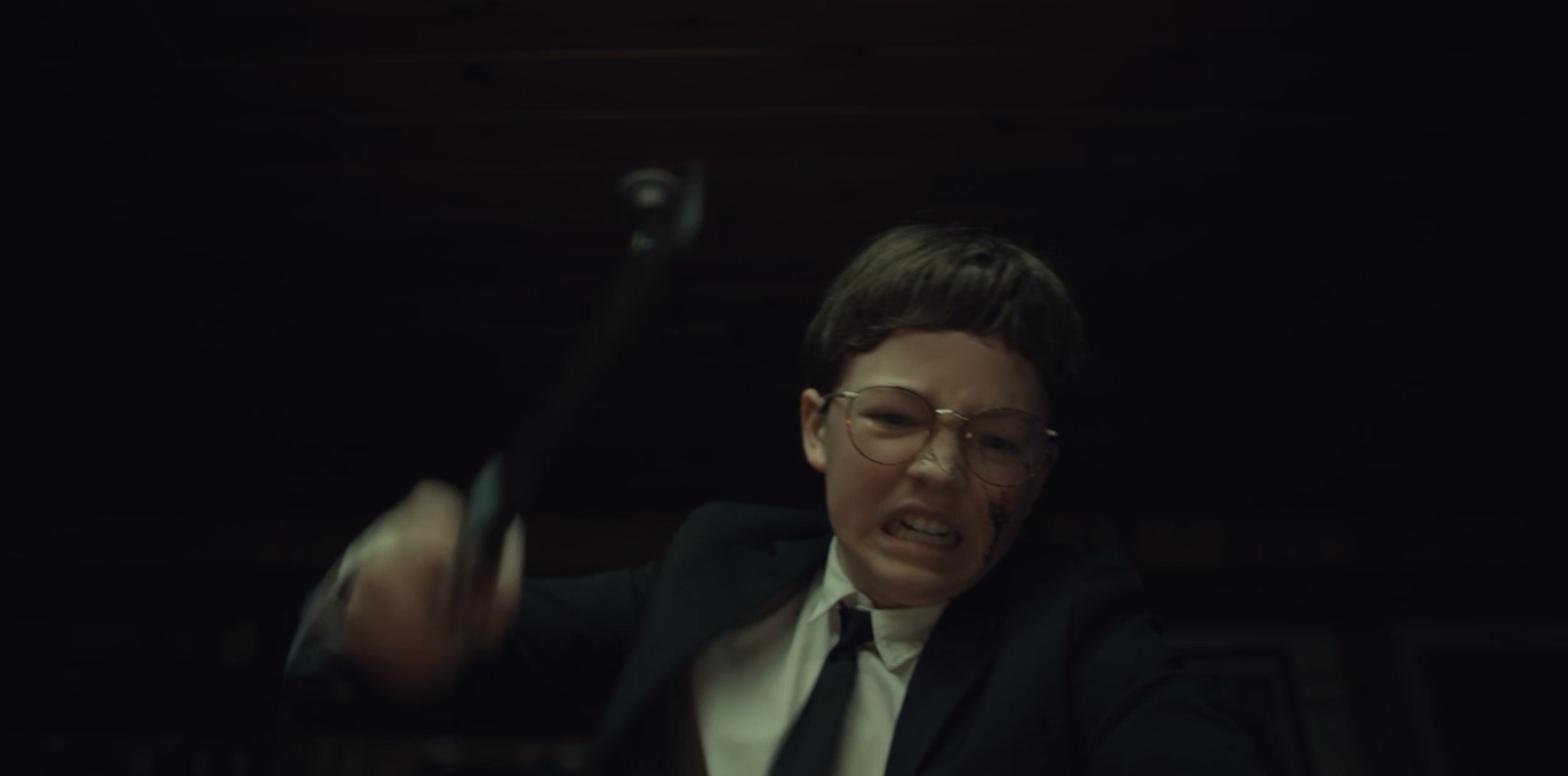 Young Hal swings a hammer at something unseen. Perkins, Osgood. The Monkey, 2025.