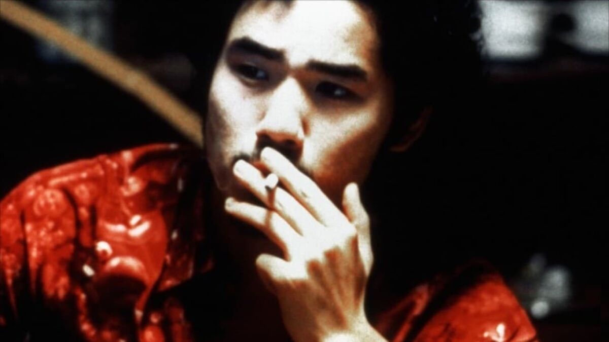 Miike, Takashi. Visitor Q. 2001. Visitor Q smoking a cigarette. Close-up shot.