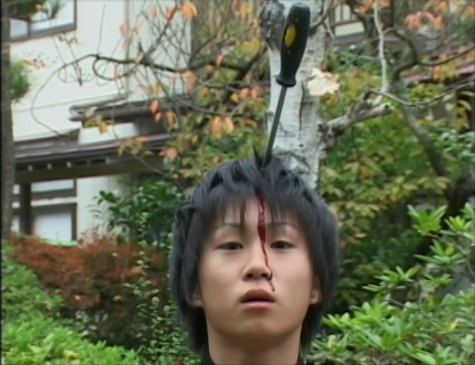 Miike, Takashi. Visitor Q. 2001. Satirical image of a young boy with a screwdriver in his head.